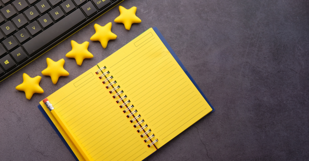 opened yellow notebook with five stars above