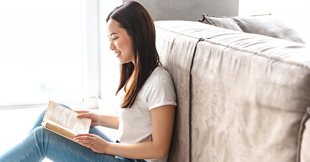 Become a better writer: Girl sitting on the floor and reading 